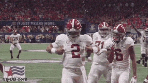 A Football Player Wearing The Number 2 Jersey Is Running With The Ball GIF