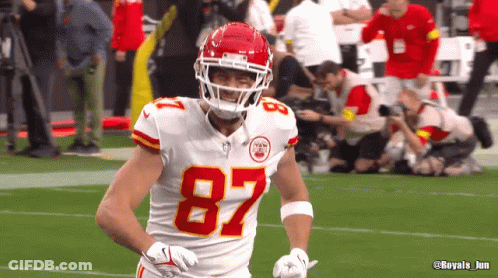 A Football Player Wearing The Number 87 On His Jersey GIF