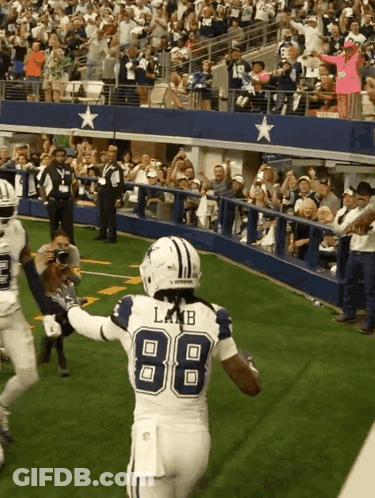 A Football Player Wearing The Number 88 Is Running On The Field GIF
