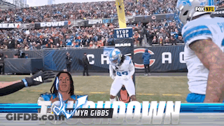 A Football Player With The Name Myr Gibbs On The Front GIF