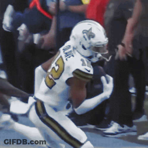 A Football Player With The Name Quake On The Back Of His Uniform GIF