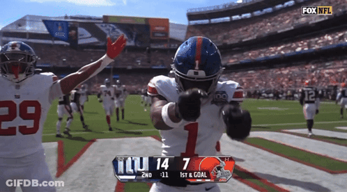 A Football Player With The Number 1 On His Helmet Stands On The Field GIF