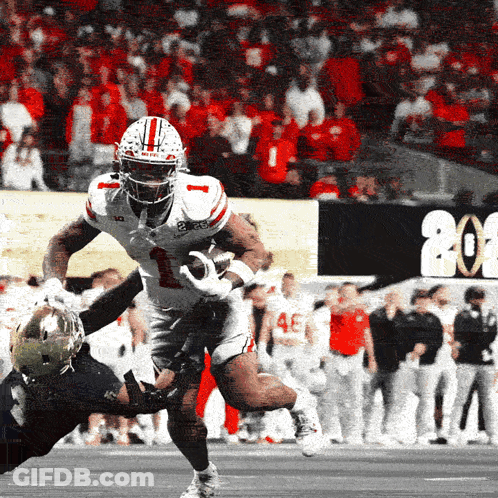 A Football Player With The Number 1 On His Jersey Is Being Tackled By Another Player GIF