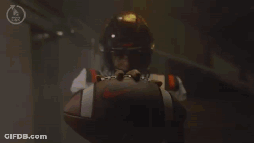 A Football Player With The Number 1 On His Jersey Is Kneeling Down Holding A Football . GIF