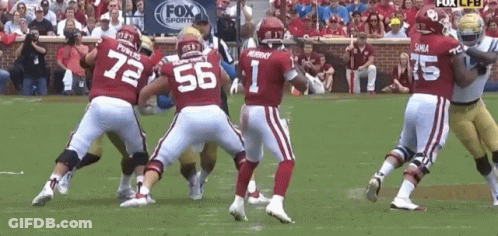 A Football Player With The Number 1 On His Jersey Is Surrounded By Other Players GIF