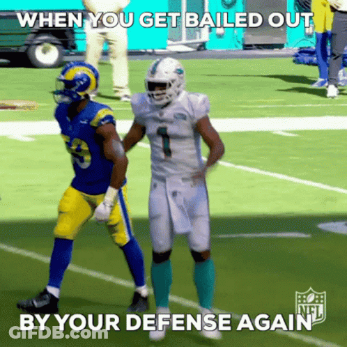 A Football Player With The Number 1 On His Jersey Stands Next To Another Player On The Field GIF