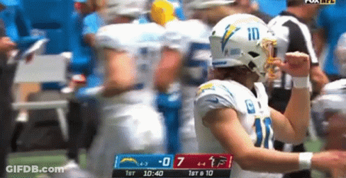 A Football Player With The Number 10 On His Helmet Celebrates GIF