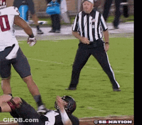 A Football Player With The Number 10 On His Jersey Is Being Tackled By Another Player GIF