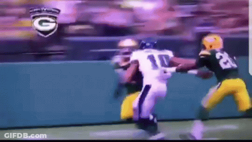 A Football Player With The Number 10 On His Jersey Is Being Tackled GIF