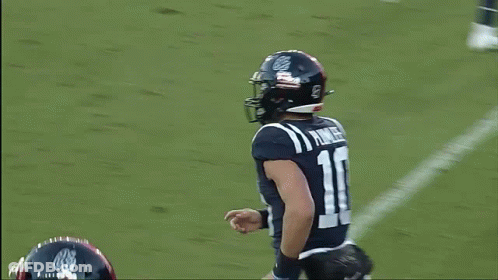 A Football Player With The Number 10 On His Jersey Is Running On The Field GIF