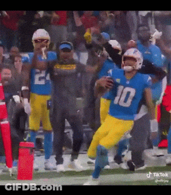 A Football Player With The Number 10 On His Jersey Is Running With The Ball GIF