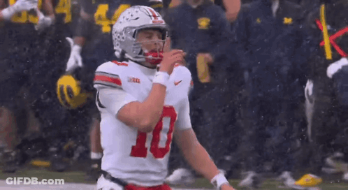 A Football Player With The Number 10 On His Jersey Is Standing On The Field GIF