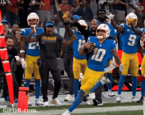 A Football Player With The Number 10 On His Jersey Runs With The Ball GIF