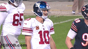 A Football Player With The Number 10 On His Jersey Stands On The Field GIF