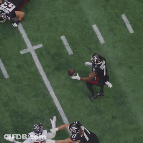 A Football Player With The Number 11 On His Jersey Catches The Ball GIF
