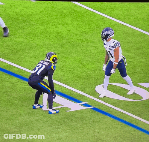 A Football Player With The Number 11 On His Jersey Is Jumping In The Air GIF