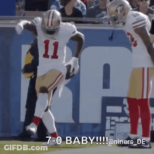 A Football Player With The Number 11 On His Jersey Is Jumping In The Air . GIF