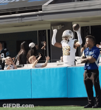 A Football Player With The Number 12 On His Jersey Catches A Ball GIF