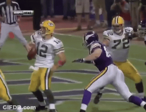 A Football Player With The Number 12 On His Jersey Is Being Tackled By Another Player GIF