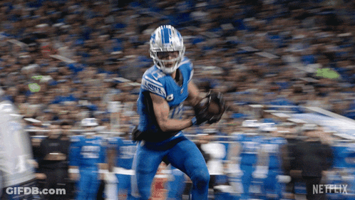 A Football Player With The Number 12 On His Jersey Is Running GIF