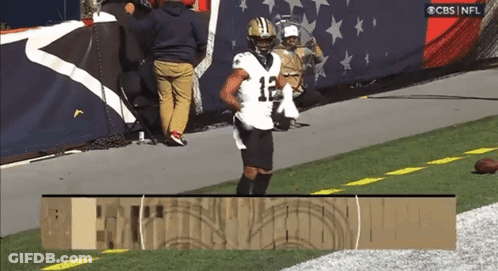 A Football Player With The Number 12 On His Jersey Is Running On The Field GIF