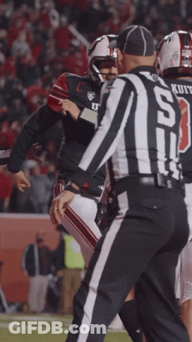 A Football Player With The Number 13 On His Jersey Talks To A Referee GIF
