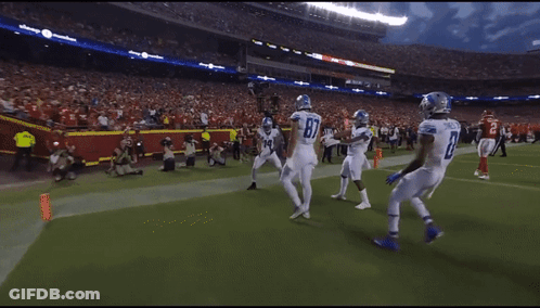 A Football Player With The Number 14 On His Jersey Celebrates With His Teammates GIF
