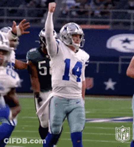 A Football Player With The Number 14 On His Jersey Is Celebrating GIF