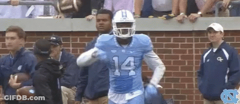 A Football Player With The Number 14 On His Jersey Is Running GIF
