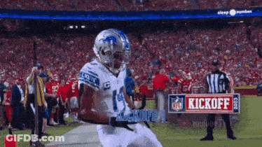 A Football Player With The Number 14 On His Jersey Runs On The Field GIF