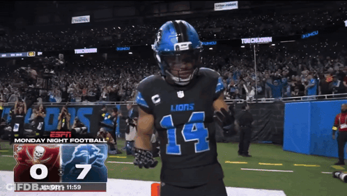 A Football Player With The Number 14 On His Jersey Stands On The Field GIF