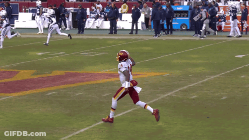 A Football Player With The Number 14 On His Jersey Stands On The Field GIF