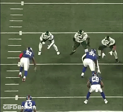 A Football Player With The Number 15 On His Jersey Is Being Tackled By Another Player . GIF