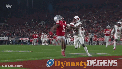 A Football Player With The Number 15 On His Jersey Is Being Tackled By Another Player On The Field GIF
