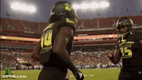 A Football Player With The Number 15 On His Jersey Is Running On The Field GIF