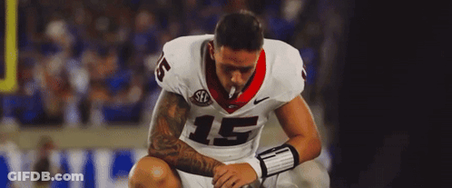 A Football Player With The Number 15 On His Jersey Is Smoking A Cigarette GIF