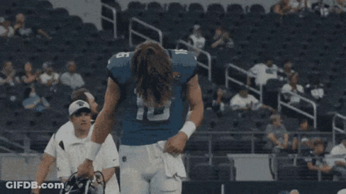 A Football Player With The Number 16 On His Jersey Stands In A Stadium GIF