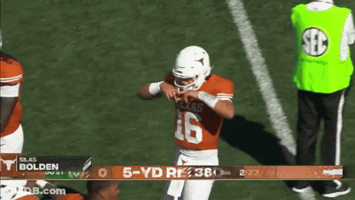 A Football Player With The Number 16 On His Jersey Stands On A Field GIF