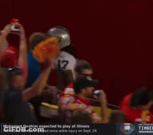 A Football Player With The Number 17 On His Jersey Is Being Helped Off The Field GIF