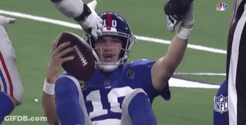 A Football Player With The Number 17 On His Jersey Is Holding A Football GIF