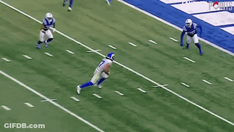 A Football Player With The Number 17 On His Jersey Is Running On The Field . GIF
