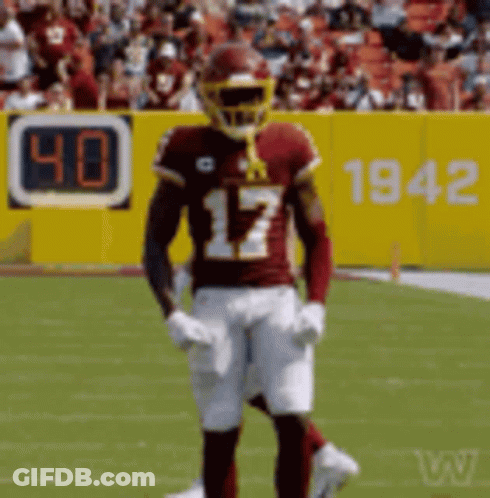 A Football Player With The Number 17 On His Jersey Stands On A Field GIF