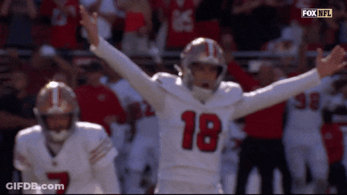 A Football Player With The Number 18 On His Jersey Is Celebrating GIF