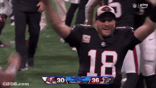 A Football Player With The Number 18 On His Jersey Is Celebrating GIF