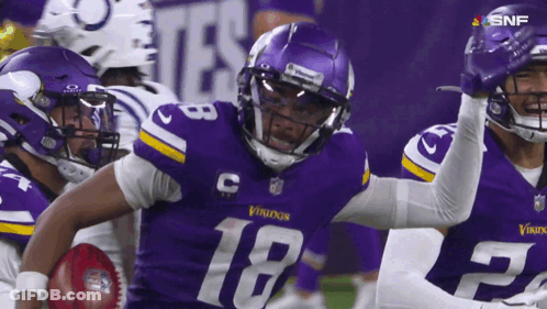 A Football Player With The Number 18 On His Jersey Is Running With The Ball GIF
