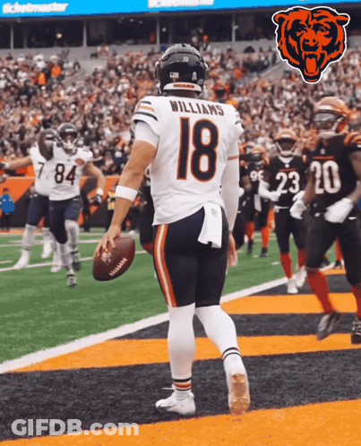 A Football Player With The Number 18 On His Jersey Stands On The Field GIF