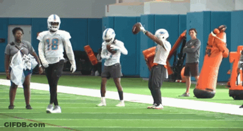A Football Player With The Number 18 On The Back Of His Helmet GIF