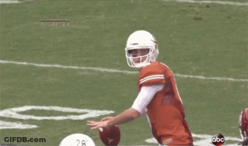 A Football Player With The Number 19 On His Jersey Is Being Tackled GIF