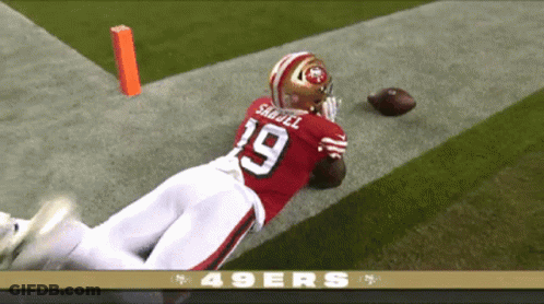 A Football Player With The Number 19 On His Jersey Is Diving For The Ball GIF