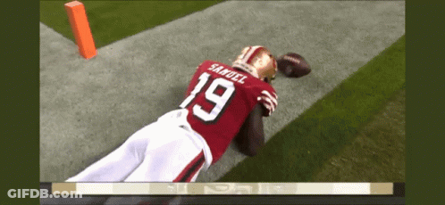 A Football Player With The Number 19 On His Jersey Is Laying On The Field GIF